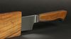 
                    The Caminada bread knife with sheath has a wooden handle