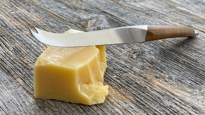 
                    cheese knife with walnut wood handle and hard cheese